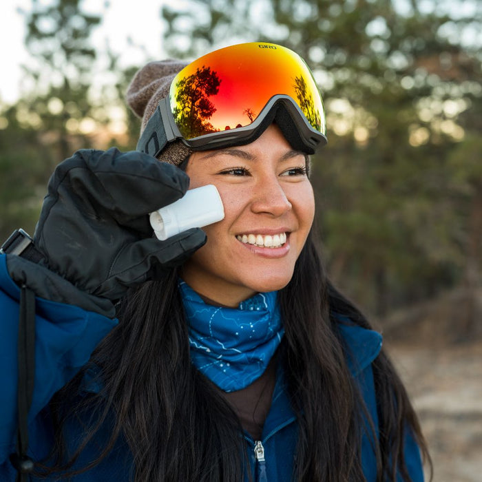 Skier applying Face the Frost to her face